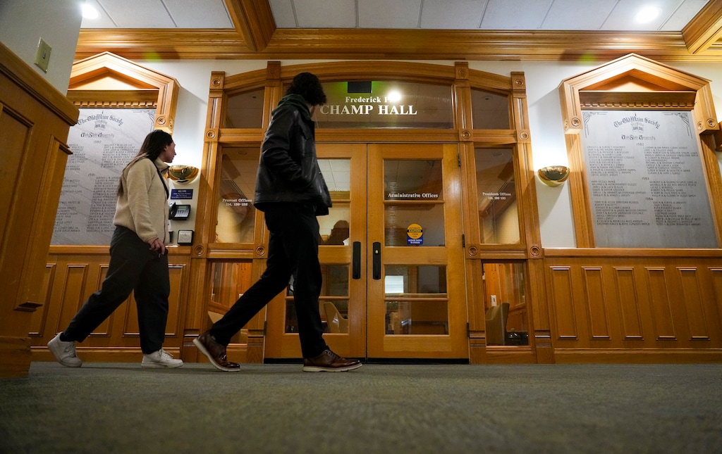 (Bethany Baker  |  The Salt Lake Tribune) People walk in front of the doors to the administration offices at Utah State University in Logan on Saturday, Feb. 8, 2025.