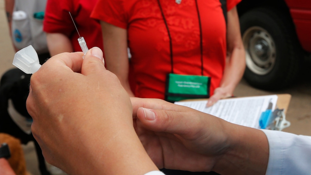 FILE - In this May 27, 2013 file photo a needle with tetanus vaccine is prepared by a nurse practitioner on a tornado ravaged street in Moore, Okla. An unvaccinated 6-year-old Oregon boy was hospitalized for two months for tetanus and almost died of the bacterial illness after getting a deep laceration on his forehead while playing on a farm, according to a case study published Friday, March 8, 2019 by the U.S. Centers for Disease Control and Prevention. (AP Photo/Sue Ogrocki,File)