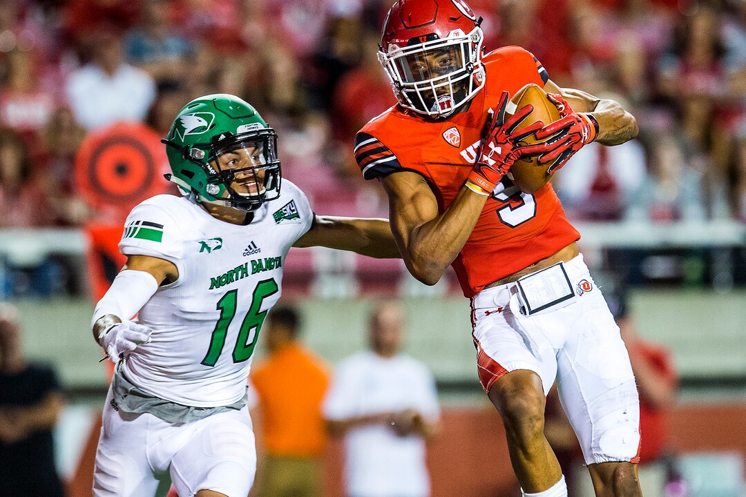 (Chris Detrick  |  The Salt Lake Tribune)  Utah Utes wide receiver Darren Carrington (9) makes a catch past North Dakota Fighting Hawks defensive back Torrey Hunt (16) during the game at Rice-Eccles Stadium Thursday, August 31, 2017. Utah Utes defeated North Dakota Fighting Hawks 37-16.