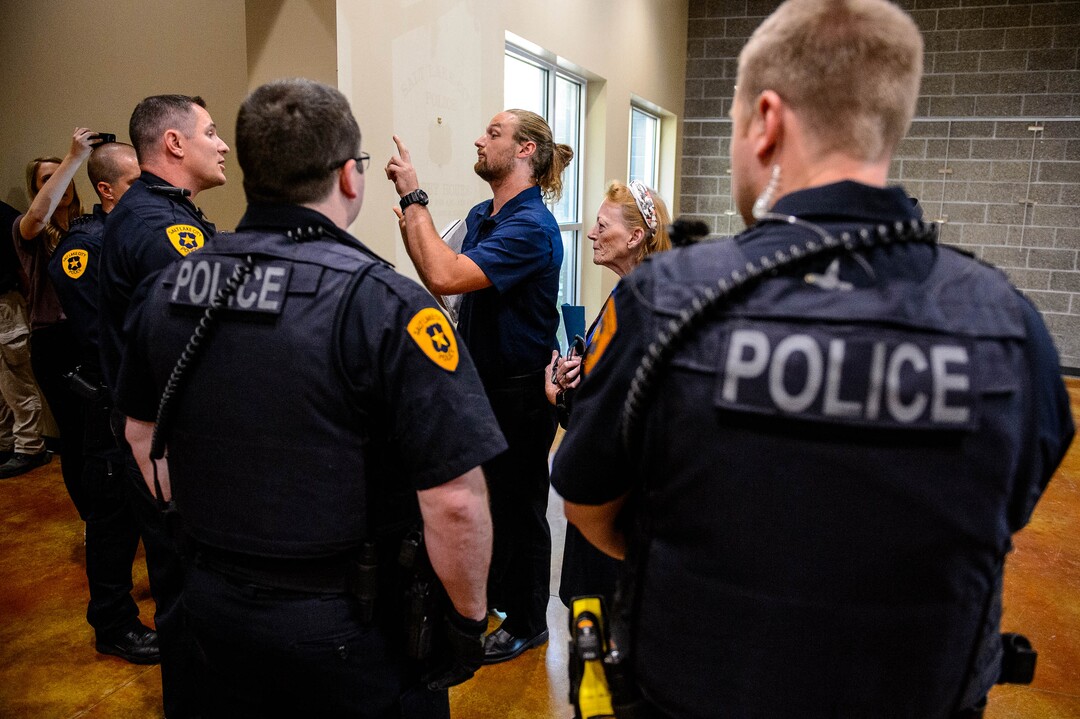(Trent Nelson  |  The Salt Lake Tribune)  
Activist Ethan Peterson argues with police who have removed him from a meeting of an inland port satellite working group held at a police precinct in Salt Lake City on Wednesday, Aug. 14, 2019. The meeting was quickly canceled soon after it began.