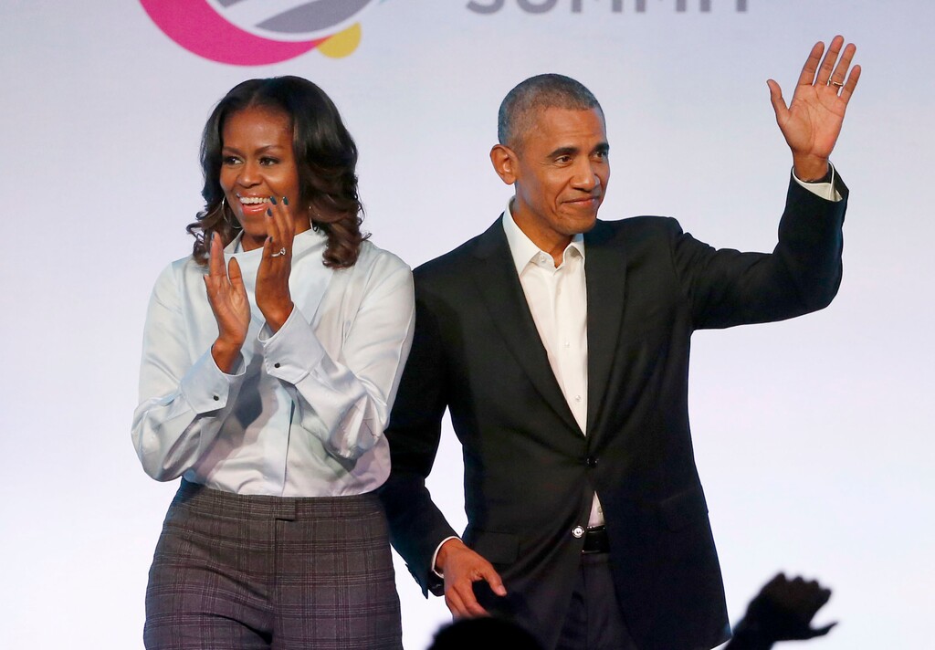 FILE - In this Oct. 31, 2017, file photo, former President Barack Obama, right, and former first lady Michelle Obama appear at the Obama Foundation Summit in Chicago. Obama said in a commencement speech Sunday, June 7, 2020, that the nationwide protests following the recent deaths of unarmed black women and men including George Floyd were fueled from "decades worth of anguish, frustration, over unequal treatment and a failure to perform police practices." (AP Photo/Charles Rex Arbogast, File)