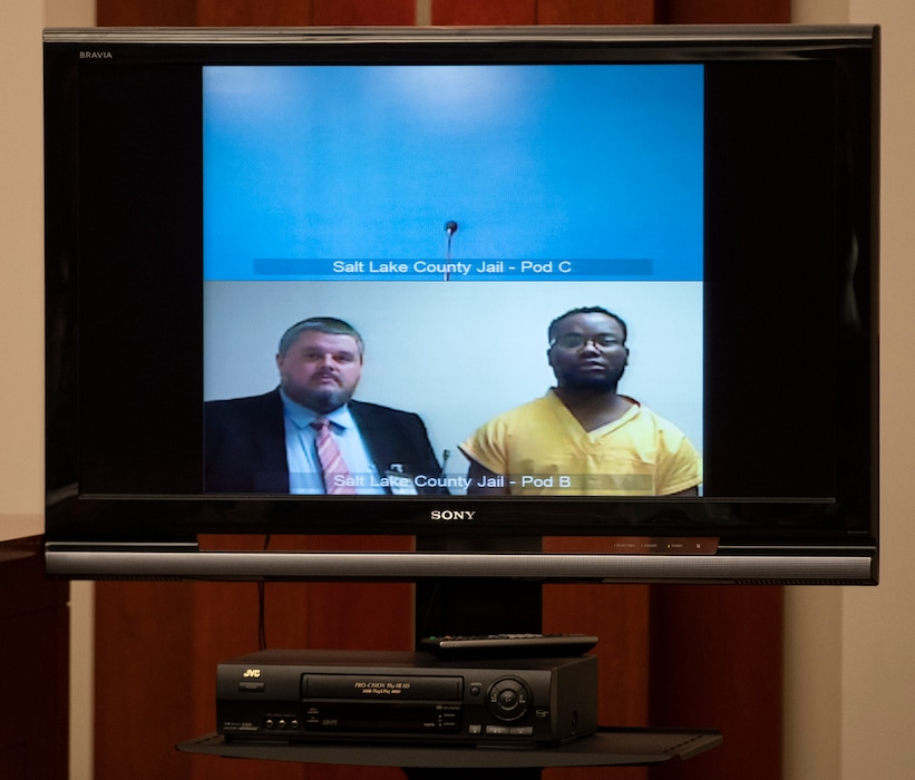 (Steve Griffin | The Deseret News/pool) Attorney Neal Hamilton, left, stands with Ayoola Adisa Ajayi as they appear on video for a preliminary hearing where Ajayi is charged with aggravated murder and aggravated kidnapping, both first-degree felonies, desecration of a human body, a second-degree felony, and obstruction of justice, a third-degree felony, in the death of University of Utah student Mackenzie Lueck. Ajayi appeared in front of Judge Mark S. Kouris at the Matheson Courthouse in Salt Lake City on Monday, July 15, 2019.