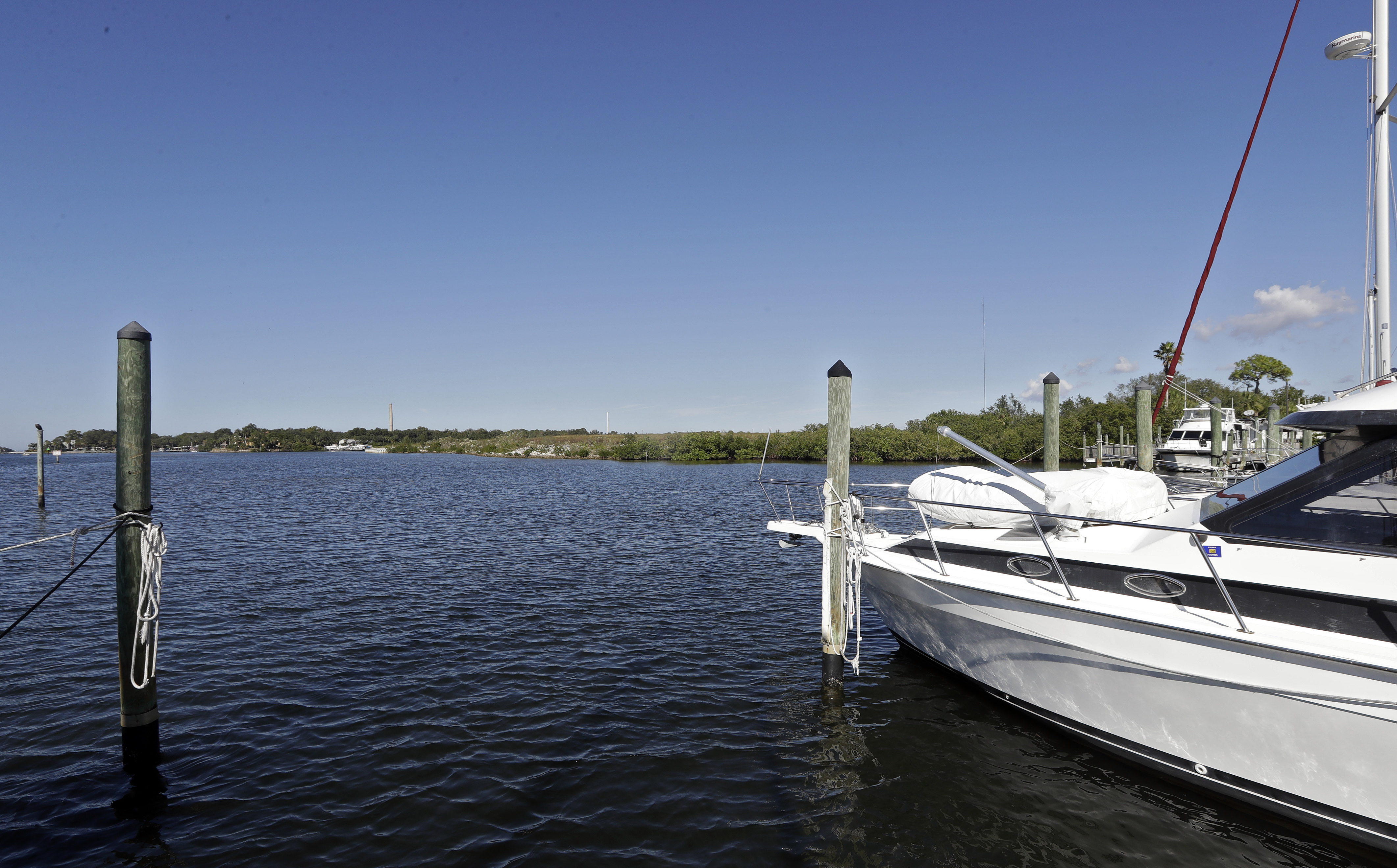 (Chris O'Meara | AP file photo) Boats are shown moored in the Anclote River near the old Stauffer chemical plant site in Tarpon Springs, Fla., in 2017. Hundreds of the nation's most polluted places are at an increasing risk of spreading contamination beyond their borders by more frequent storms and rising seas. Sixty percent of U.S. Superfund sites are in danger from weather extremes like hurricanes or wildfires, and the Trump administration’s reluctance to acknowledge and plan for climate change is hurting chances of safeguarding them, according to a government watchdog.