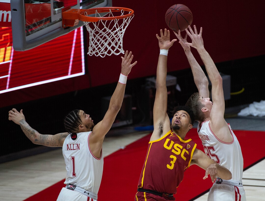 (Francisco Kjolseth  | The Salt Lake Tribune) Utah Utes forward Timmy Allen (1) and Utah Utes center Branden Carlson (35) take on USC Trojans forward Isaiah Mobley (3) for a rebound in PAC-12 basketball action at the Jon M. Huntsman Center, on Saturday, Feb. 27, 2021.