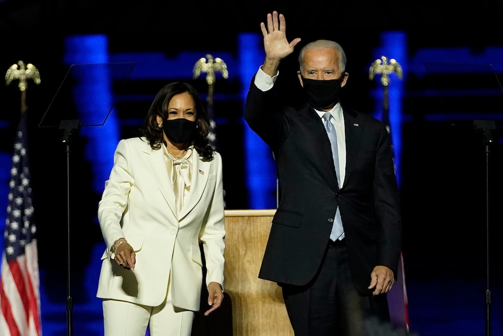 (AP Photo/Andrew Harnik, Pool) President-elect Joe Biden, right, shares the stage with Vice President-elect Kamala Harris, left, Saturday, Nov. 7, 2020, in Wilmington, Del.