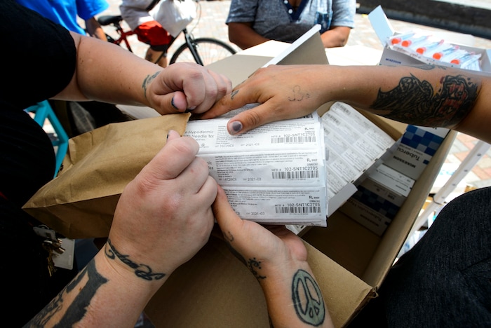 (Steve Griffin  |  The Salt Lake Tribune)  Volunteers Jenna Vitdenhowen and Crystal help members from of Utah Harm Reduction Coalition as they exchange needles on 500 west between 200 south and 300 south in Salt Lake City Thursday July 27, 2017. The state's increased attention to the Rio Grande neighborhood comes as Utah's leading needle exchange provider is under fire for handing out many times more needles than it collects. Mindy Vincent, founder of the coalition, says the goal was never to break even, and that optics aside, needle exchange is proven to reduce the spread of disease among IV drug users.