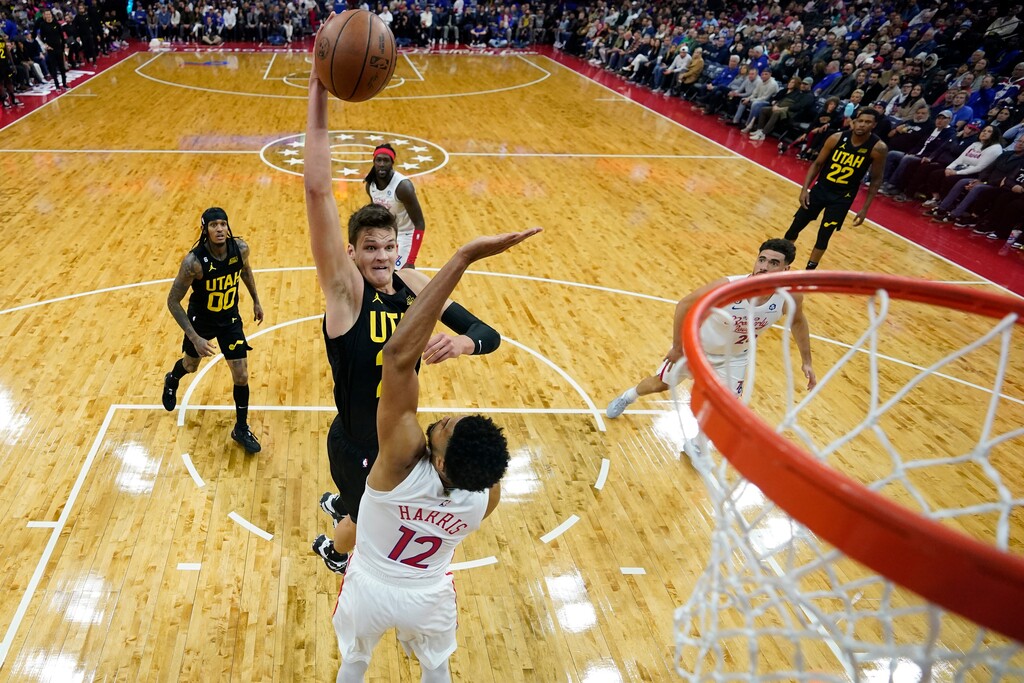 Utah Jazz's Walker Kessler, left, goes up for a dunk against Philadelphia 76ers' Tobias Harris during the first half of an NBA basketball game, Sunday, Nov. 13, 2022, in Philadelphia. (AP Photo/Matt Slocum)