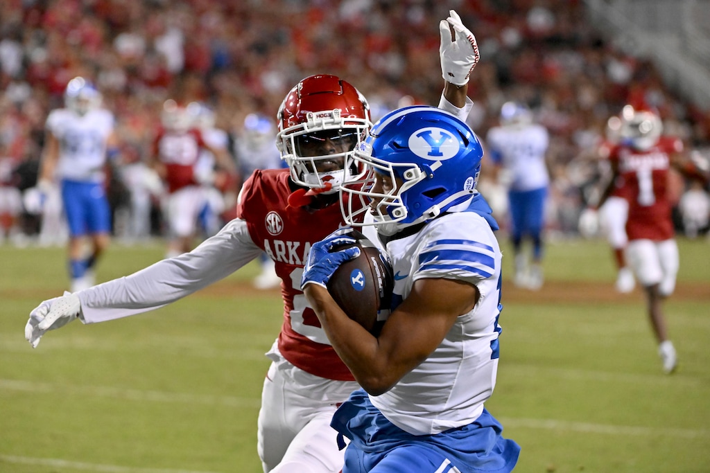 BYU wide receiver Keelan Marion (17) makes a catch in front of Arkansas defensive back Dwight McGlothern (2) during the second half of an NCAA college football game Saturday, Sept. 16, 2023, in Fayetteville, Ark. (AP Photo/Michael Woods)