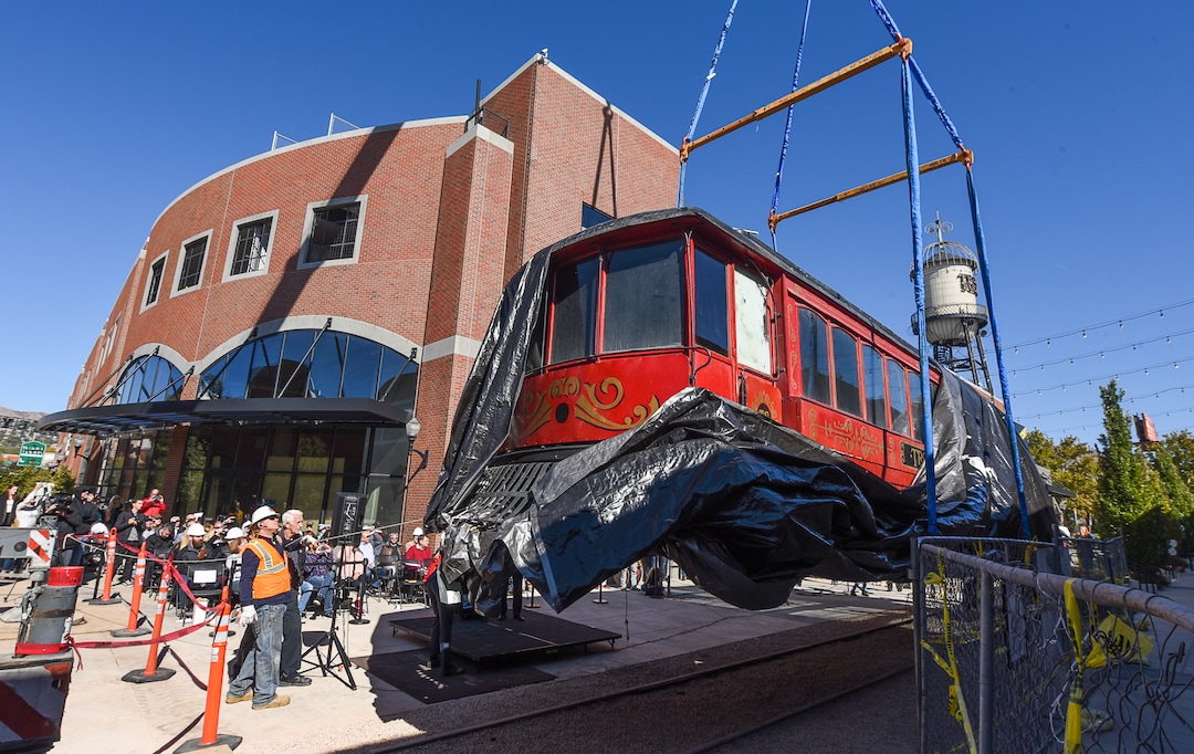 (Francisco Kjolseth  |  Francisco Kjolseth)  The iconic trolley car, that has been sitting in storage for several years, is moved back into view at Trolley Square on Monday, Oct. 15, 2018 as people gather for the repositioning ceremony. The empty trolley car, last seen housing the Trolley Wing Company was moved into place on the north plaza by Pottery Barn.