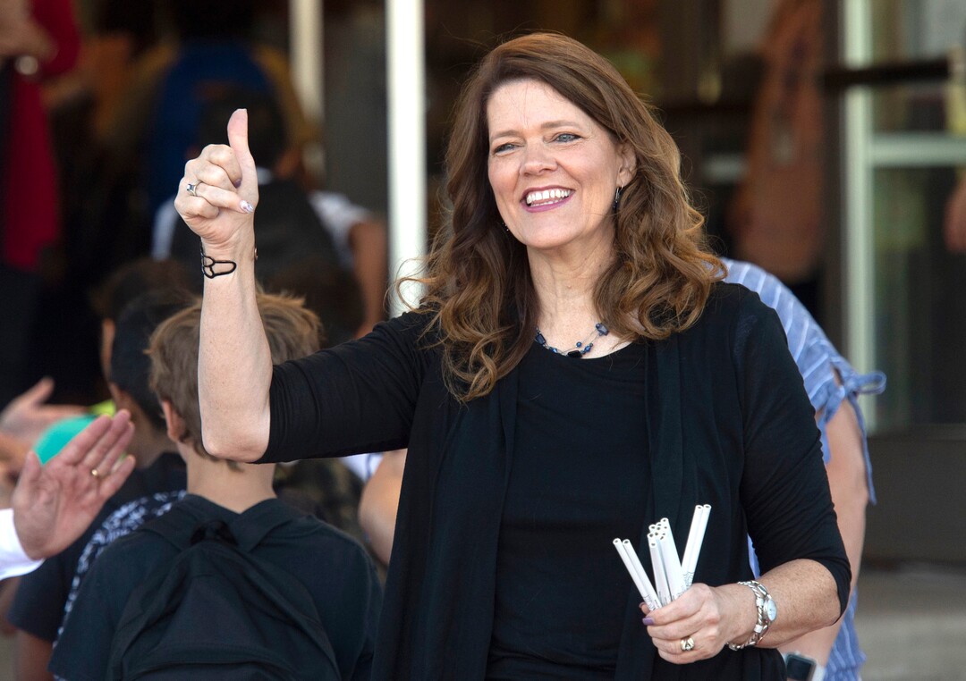 (Rick Egan  |  The Salt Lake Tribune)         Jeri Rigby, the new principal of Copperview Elementary School, cheers for her teachers and their students as they walk the red carpet on the first day of school, Monday, Aug. 19, 2019.