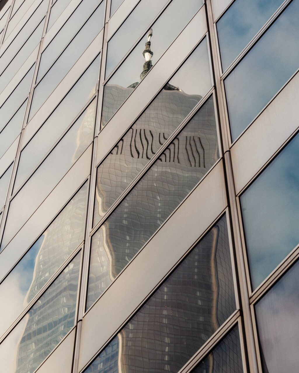 (George Etheredge for The New York Times)

The facade of Goldman Sachs headquarters, reflecting One World Trade Center in Manhattan.