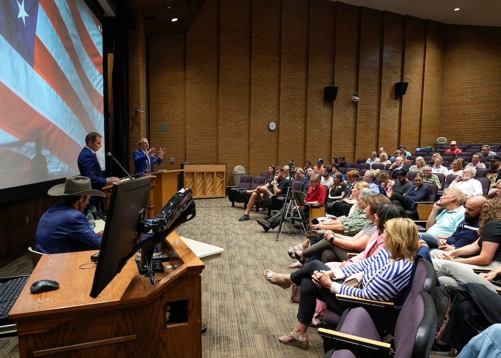 (Leah Hogsten | The Salt Lake Tribune) Utah's Third Congressional District Incumbent Rep. John Curtis debates challenger Chris Herrod, Friday, May 27, 2022, at the Spencer W. Kimball Tower on the campus of Brigham Young University ahead of the June 28 primary election. Utah Republican Party Chair Carson Jorgensen, left, moderated the event.