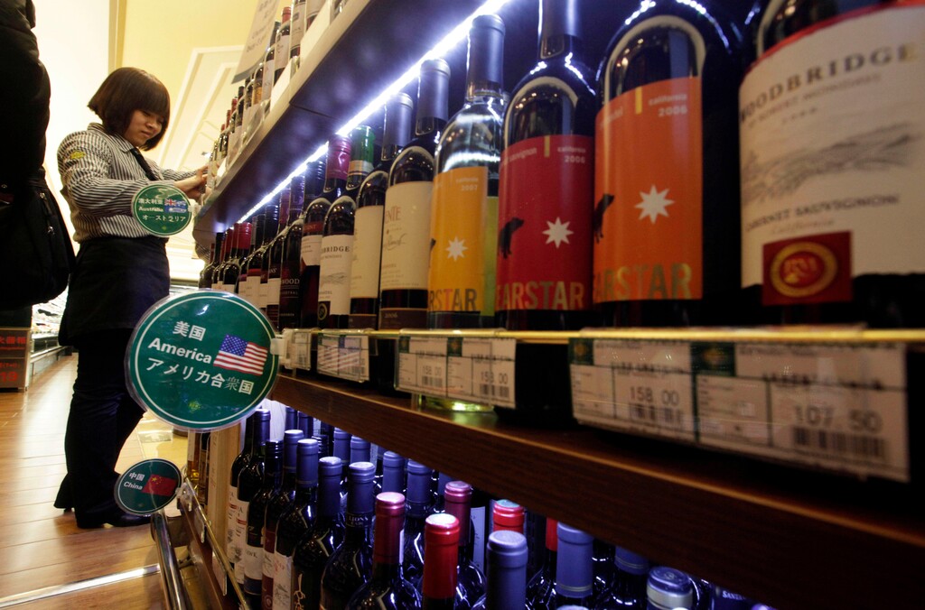 FILE - In this Jan. 30, 2011, file photo, wine imported from the U.S. is displayed at a supermarket in Beijing. China announced a list of U.S. goods including pork, apples and steel pipe on Friday, March 23, 2018, that it said may be hit with higher import duties in response to President Donald Trump's tariff hike on steel and aluminum. (AP Photo/Ng Han Guan, File)