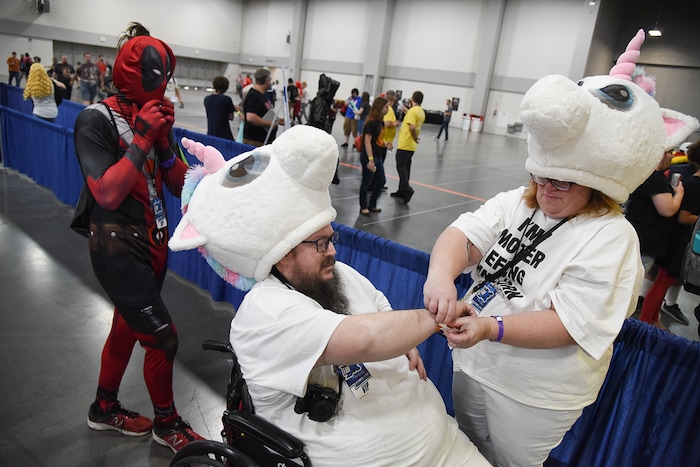(Francisco Kjolseth  |  The Salt Lake Tribune)  Scott and Valerie Guyant along with their son Gryphon dress as characters from the movie Deadpool as they attend the start of FanX Salt Lake Comic Convention at the Salt Palace in Salt Lake City Thursday, Sept. 6, 2018, during the three-day pop culture convention.