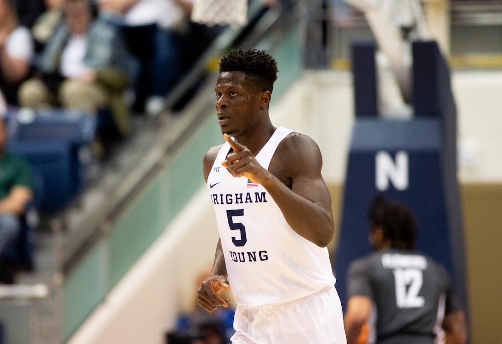 (Rachel Rydalch | The Salt Lake Tribune) Brigham Young Cougars forward Gideon George (5) points after a score in the first quarter during the NIT quarter finals game between the Brigham Young Cougars and the Washington State Cougars on Wednesday, March 23, 2022.