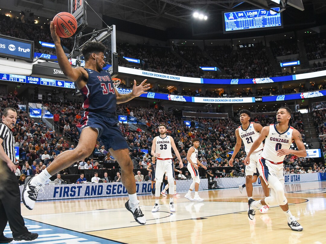 (Francisco Kjolseth  |  The Salt Lake Tribune)  Fairleigh Dickinson Knights forward Mike Holloway Jr. (34) manages to keep the ball in play as Gonzaga faces Fairleigh Dickinson in their first round menÕs NCAA March Madness tournament game at Vivint Smart Home Arena in Salt Lake City on Thursday, March 21, 2019.