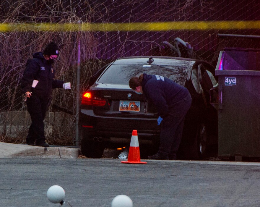 (Rick Egan | The Salt Lake Tribune) Police examine a BMW the was involved in a shooting in Kearns, in an LDS church parking lot, where one person was killed and two were injured, on Tuesday, March 9, 2021.