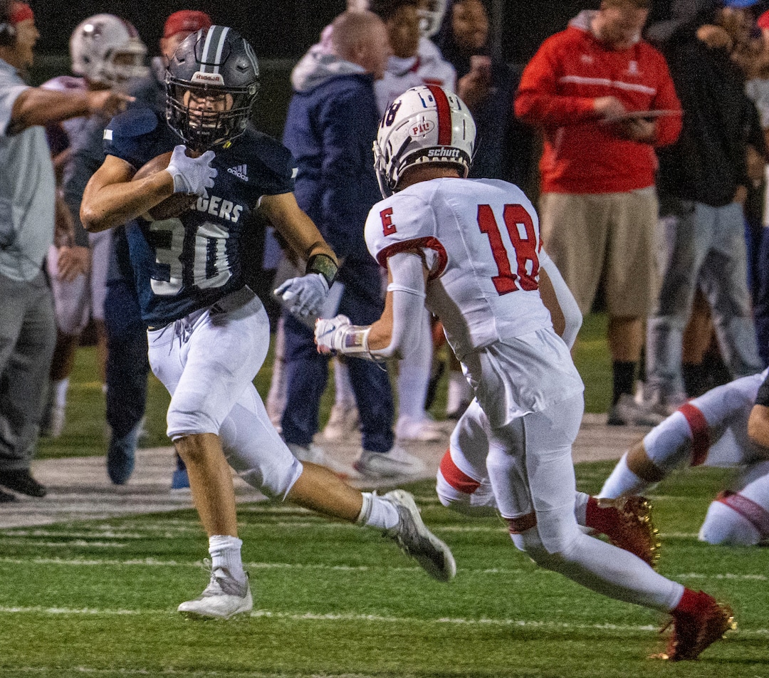(Rick Egan | The Salt Lake Tribune) The Chargers Dylan Carlsen (30) runs the ball, as East High, running back Spencer Black (18) defends, in prep football action between Corner Canyon Chargers and the East Leopards, on Saturday, Aug. 21, 2021. He did not return to the game.