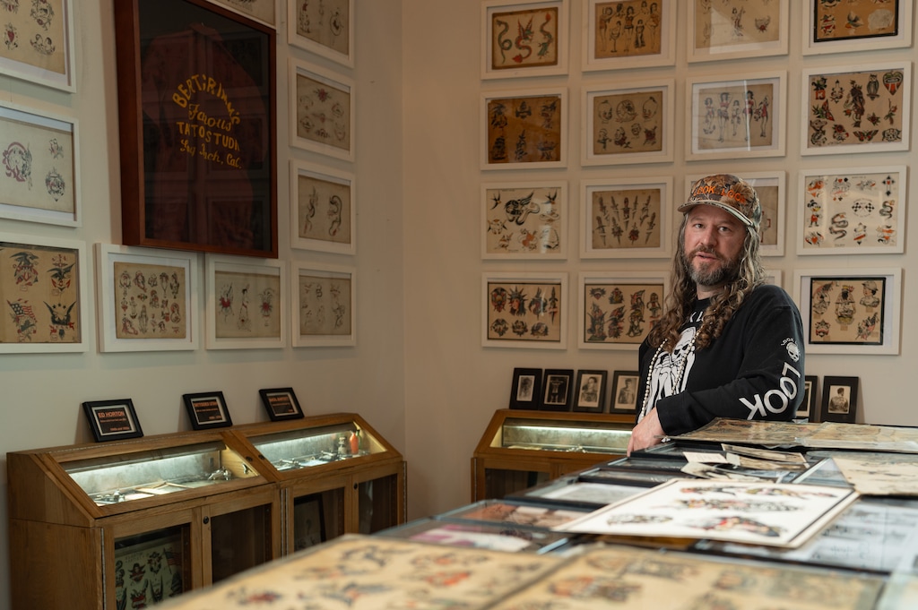 (Trent Nelson | The Salt Lake Tribune) CJ Fishburn, tattooist and proprietor of Look Look Tattoo in Salt Lake City, with his historic collection on Wednesday, Nov. 19, 2025.