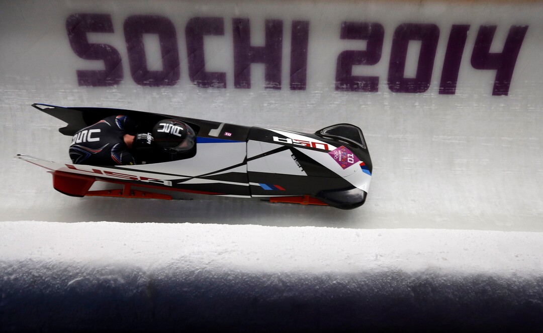 The team from the United States USA-1, piloted by Steven Holcomb and brakeman Steven Langton, take a curve during the men's two-man bobsled competition at the 2014 Winter Olympics, Monday, Feb. 17, 2014, in Krasnaya Polyana, Russia. (AP Photo/Natacha Pisarenko)