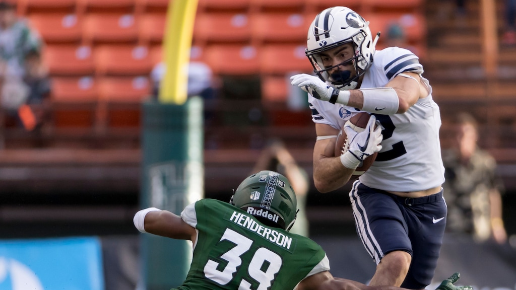 BYU running back Austin Kafentzis (2) attempts to get by Hawaii defensive back Trayvon Henderson (39) in the first quarter of an NCAA college football game, Saturday, Nov. 25, 2017, in Honolulu. (AP Photo/Eugene Tanner)