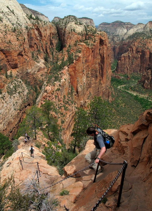 FILE - In this May 8, 2011, file photo, hikers climb down the Angels Landing trail in Zion National Park, in Utah. Zion National Park officials say a 13-year-old girl has fallen to her death from a popular narrow trail bordered by steep drops. (Jud Burkett /The Spectrum & Daily News via AP, File)