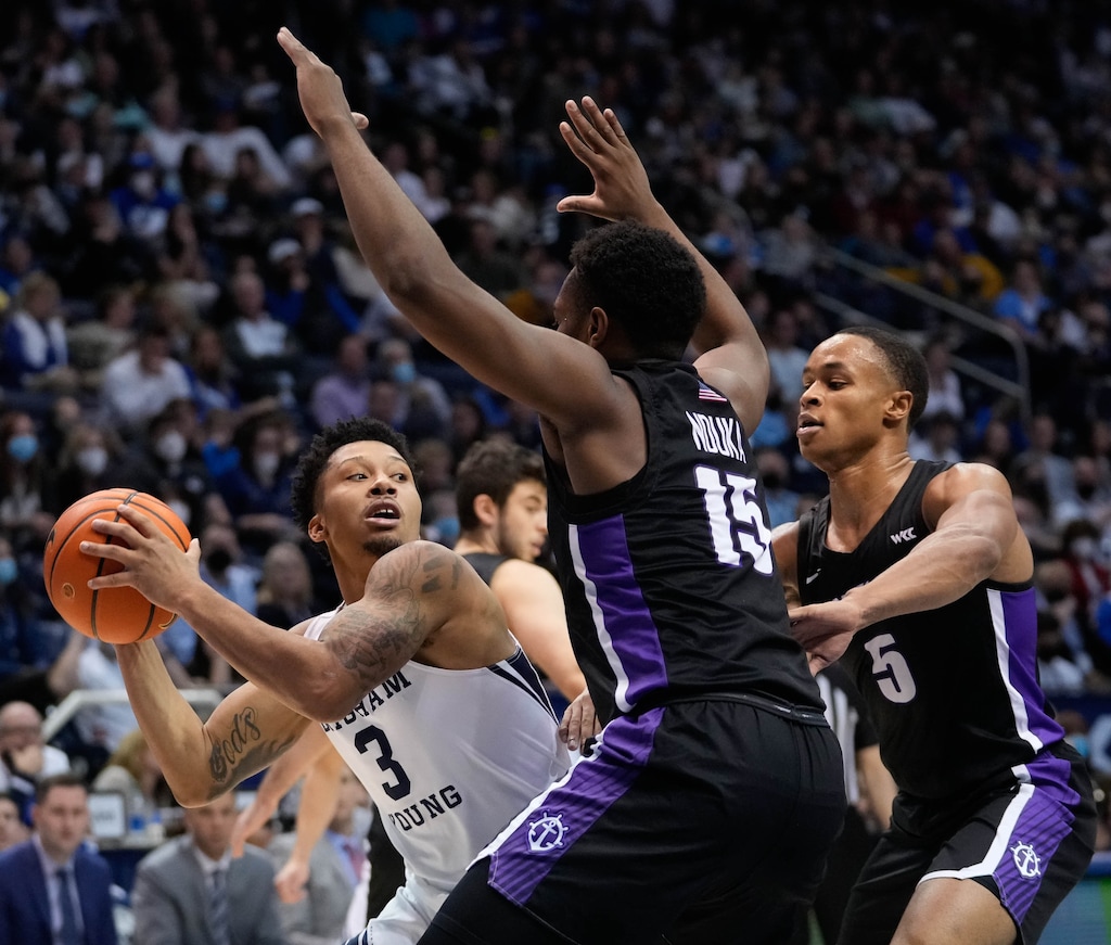 (Francisco Kjolseth | The Salt Lake Tribune) Brigham Young Cougars guard Te'Jon Lucas (3) tries to find and open teammate past Portland Pilots guard Chika Nduka (15) and Portland Pilots guard Chris Austin (5) in WCC basketball action between the Brigham Young Cougars and the Portland Pilots, at the Marriott Center, on Saturday, January 22, 2022.