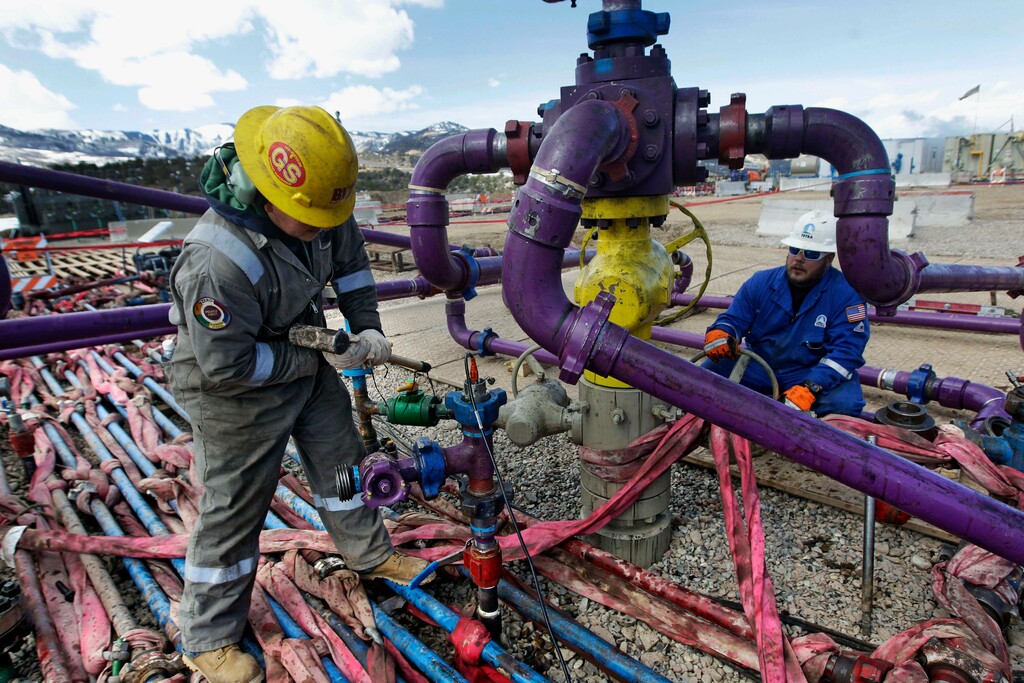 (Brennan Linsley | AP file photo)
In this March 29, 2013, photo, workers tend to a well head during a hydraulic fracturing operation outside Rifle, in western Colorado. The Interior Department said Friday, Feb. 12, 2021 that it is postponing onshore and offshore oil lease sales planned for next month in line with President Joe Biden's executive order on climate change.