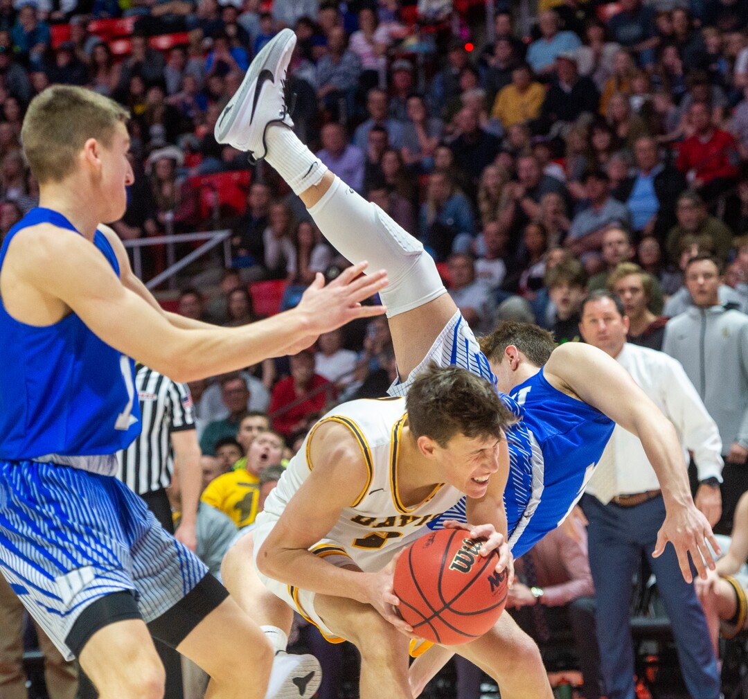 (Rick Egan  |  The Salt Lake Tribune)   Fremont Silverwolves Mitch Stratford (12)   lands onto of Davis High forward Spencer Vernon (2), in the 6A championship game at the Jon M. Huntsman Center, Saturday Feb. 29, 2020