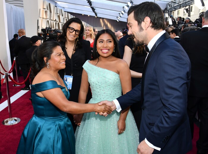 Margarita Martinez Merino, left, shakes hands with Diego Luna, right, as Yalitza Aparicio looks on during arrivals at the Oscars on Sunday, Feb. 24, 2019, at the Dolby Theatre in Los Angeles. (Photo by Charles Sykes/Invision/AP)