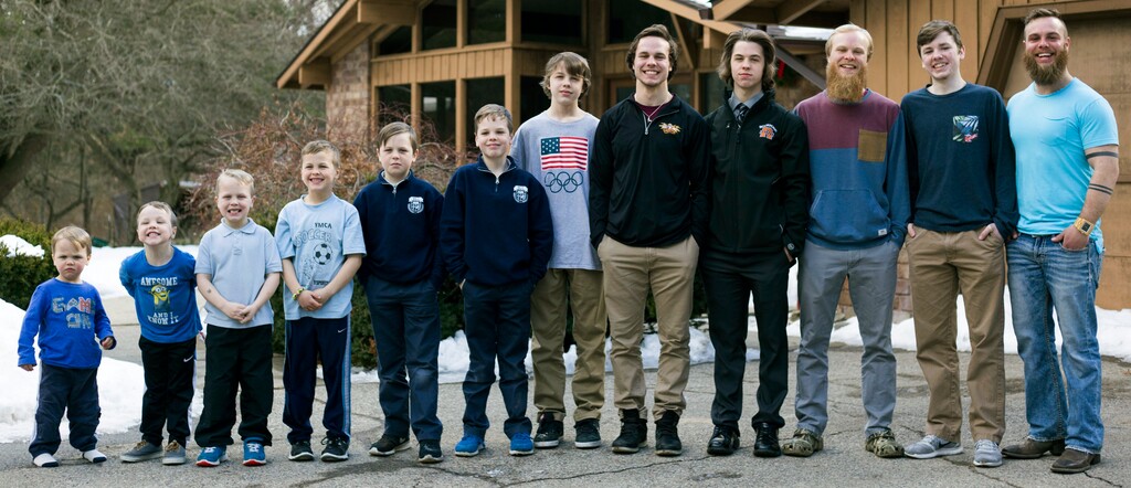 (Casey Sykes | The Grand Rapids Press | The Associated Press) In this Friday, Feb. 16, 2018 photo, from left to right, brothers Francisco, 2, Tucker, 4, Luke, 6, Charlie, 8, Gabe, 11, Wesley, 9, Calvin, 13, Drew, 20, Tommy, 16, Zach, 22, Vinny, 15, and Ty Schwandt, 25, pose for a portrait at the Schwandt household in Grand Rapids, Mich. The only brother not pictured is Brandon, 18. The Schwandt family has 13 sons and have welcomed a 14th into the family. The couple's latest addition was born Wednesday evening, April 18 five days before the baby's expected due date.