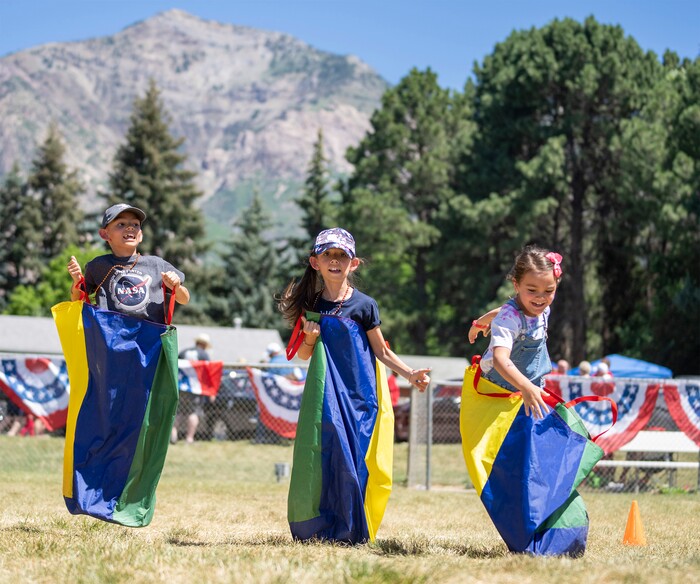 (Rick Egan | The Salt Lake Tribune) Kids compete in the sack races, at  the Cherry Days Fourth of July celebration, in North Ogden, on Monday, July 4, 2022.
