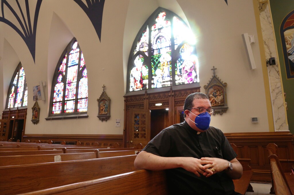 (Jessie Wardarski | AP file photo) The Rev. Manuel Rodriguez sits in the pews of his church, Our Lady of Sorrows, on March 5, 2021, in the Queens borough of New York. A new survey by the Pew Research Center, Tuesday, March 28, 2023, says in-person attendance at religious services in the U.S. declined during the COVID-19 pandemic. But Rodriguez says attendance is now higher at his Catholic church than before the pandemic, even though more than 100 of his parishioners died of COVID.