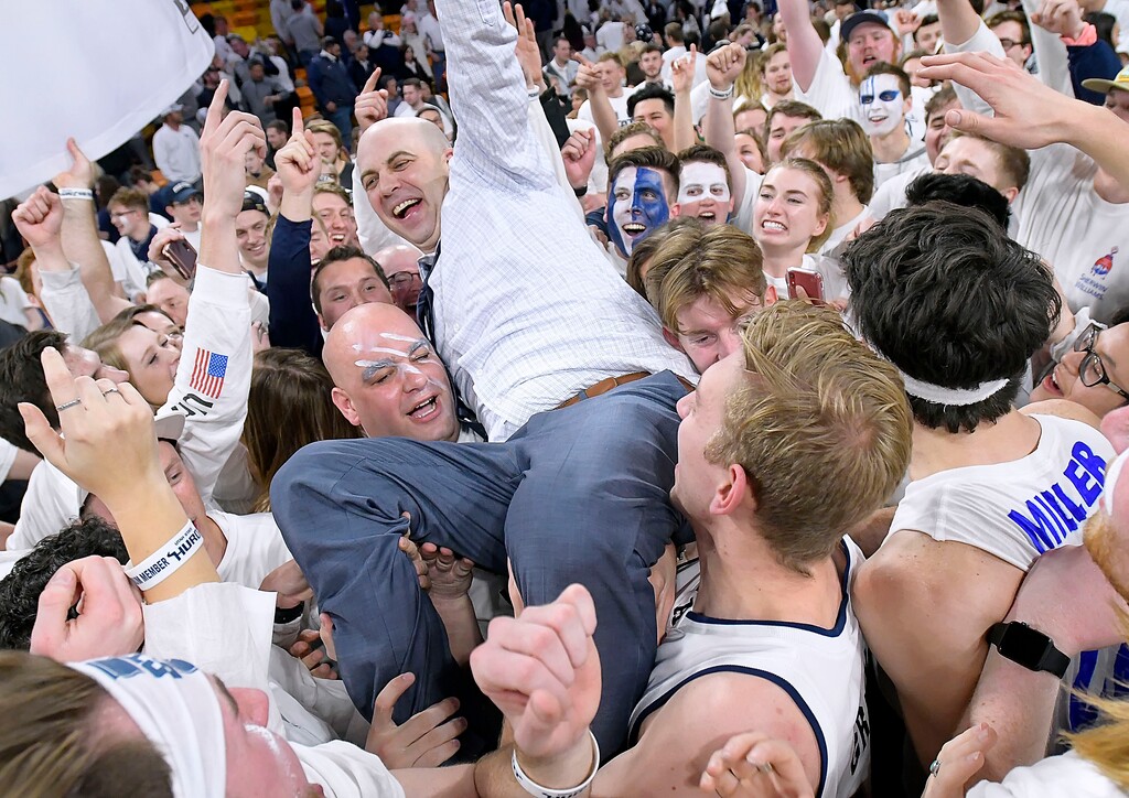 (Eli Lucero  |  The Herald Journal via AP) Utah State coach Craig Smith celebrates with fan on the court after Utah State defeated No. 12 Nevada 81-76 in an NCAA college basketball game Saturday, March 2, 2019, in Logan, Utah. Smith will have a homecoming of sorts when his Aggies team opens the season at the Bad Boy Mowers Crossover Classic on Nov. 25, 2020, in South Dakota, where Smith coached from 2014-18.