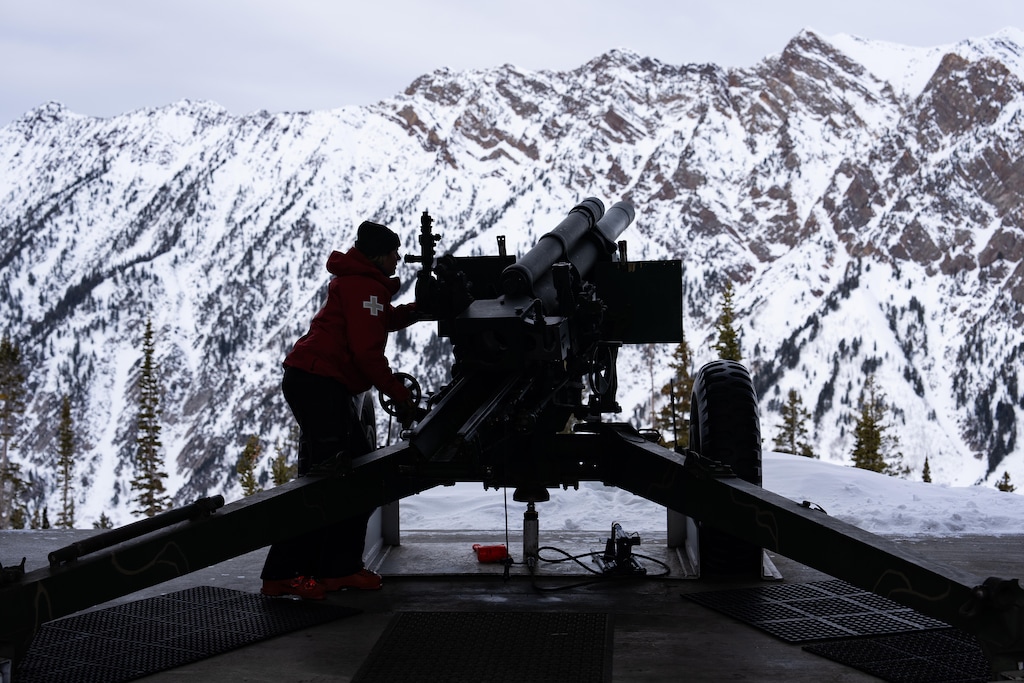 (Ruth Fremson | The New York Times) A ski patroller adjusts a howitzer that shoots rounds across Little Cottonwood Canyon to trigger preemptory avalanches.