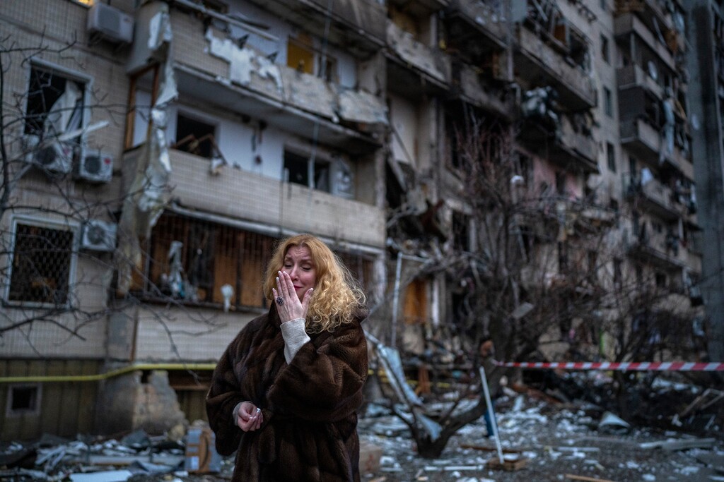 (Emilio Morenatti | AP) Natali Sevriukova reacts next to her house following a rocket attack the city of Kyiv, Ukraine, Friday, Feb. 25, 2022.