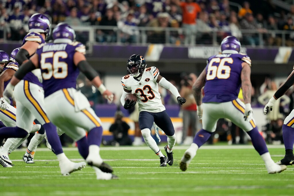 Chicago Bears cornerback Jaylon Johnson (33) runs up field after intercepting a pass during the first half of an NFL football game against the Minnesota Vikings, Monday, Nov. 27, 2023, in Minneapolis. (AP Photo/Abbie Parr)