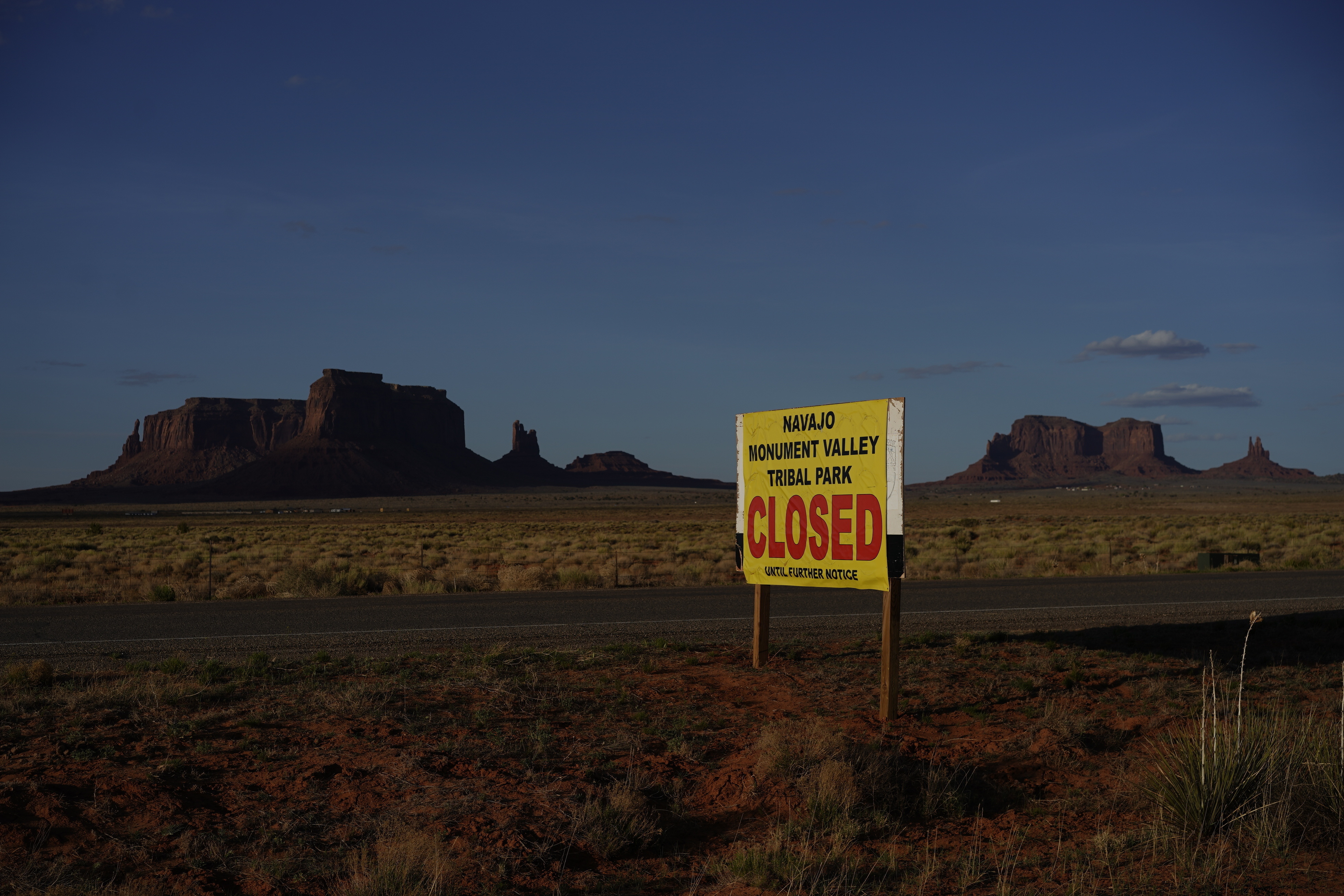This April 23, 2020 photo shows a sign posted in Oljato-Monument Valley, Utah, saying the Navajo Monument Vally Tribal Park is closed, in an effort to prevent the spread of COVID-19 on the Navajo reservation. The reservation has some of the highest rates of coronavirus in the country. (AP Photo/Carolyn Kaster)