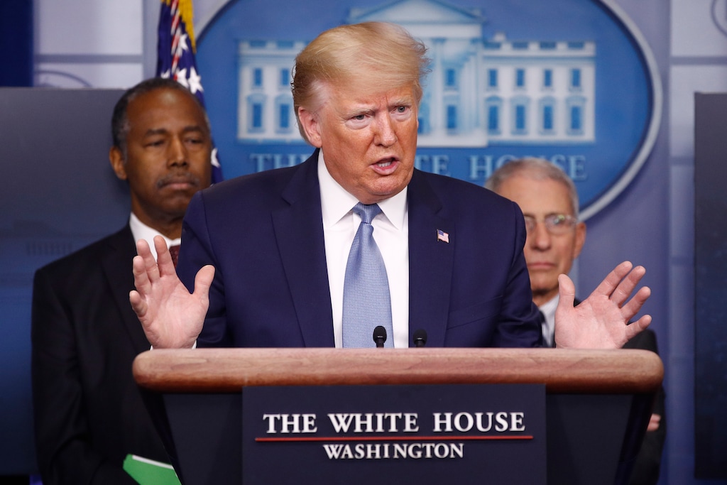 (Patrick Semansky | AP) President Donald Trump speaks during a coronavirus task force briefing at the White House, Saturday, March 21, 2020, in Washington.Housing and Urban Development Secretary Ben Carson, left, and Director of the National Institute of Allergy and Infectious Diseases Dr. Anthony Fauci listen.