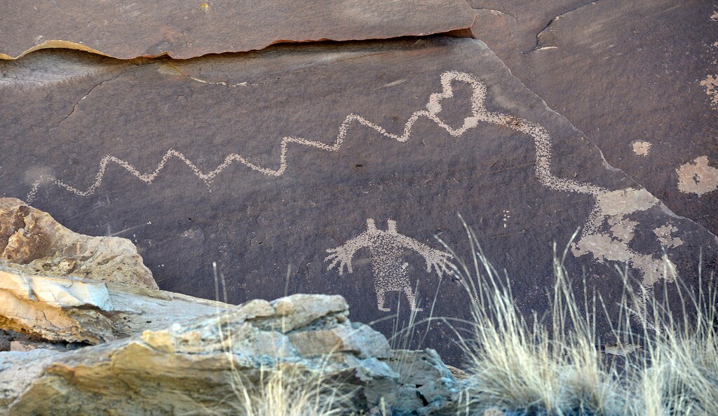 (Al Hartmann  |  Tribune file ) Fremont petroglyph of snake and figure called "Cowboy Secret" tucked beneath jumbled sandstone caprock in the Molen Reef area of the San Rafael Swell. The Bureau of Land Management recently blocked at least 14 staff archaeologists from presenting their views at a scientific conference on managing archaeologic riches on public lands.