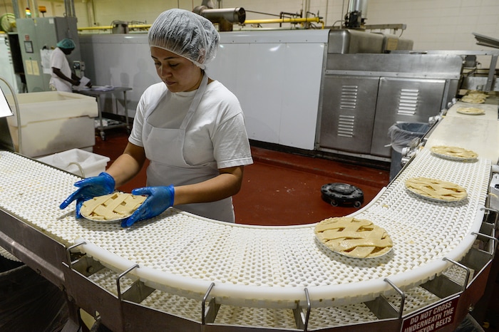 Francisco Kjolseth | The Salt Lake TribuneEsmeralda Magana puts the finishing touch on hand laid lattice apple pie's at Rocky Mountain Pie factory in Salt Lake before they move on into the ovens during a recent run. 