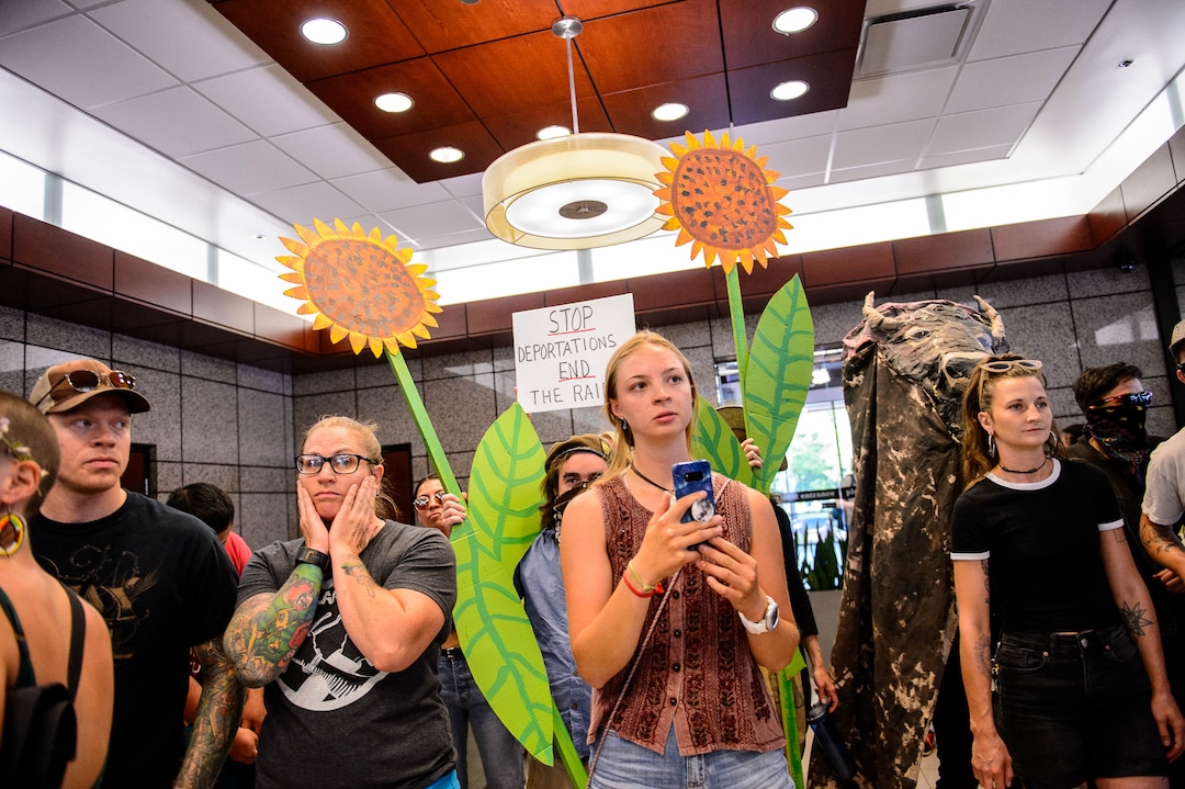 (Trent Nelson  |  The Salt Lake Tribune) Protesters occupy the lobby of the Chamber of Commerce Building in Salt Lake City on Tuesday July 9, 2019. Dozens of people showed up to protest the proposed Inland Port and ended up clashing with police, resulting in temporary street closures and arrests.