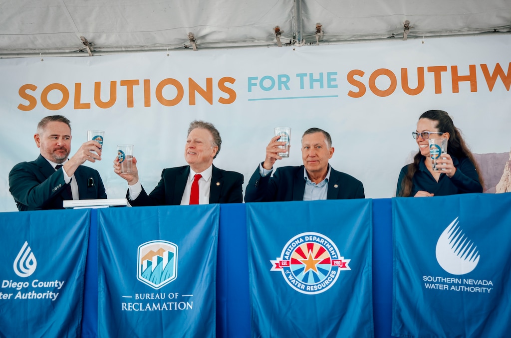 (Sandy Huffaker | The New York Times) From left, Dan Denham of the San Diego County Water Authority; Scott Cameron of the U.S. Bureau of Reclamation; Tom Buschatzke of the Arizona Department of Water Resources; and Colby Pellegrino of the Southern Nevada Water Authority toast with glasses of water at the Carlsbad Desalination Plant in Carlsbad, Calif., on Wednesday, June 3, 2026. 