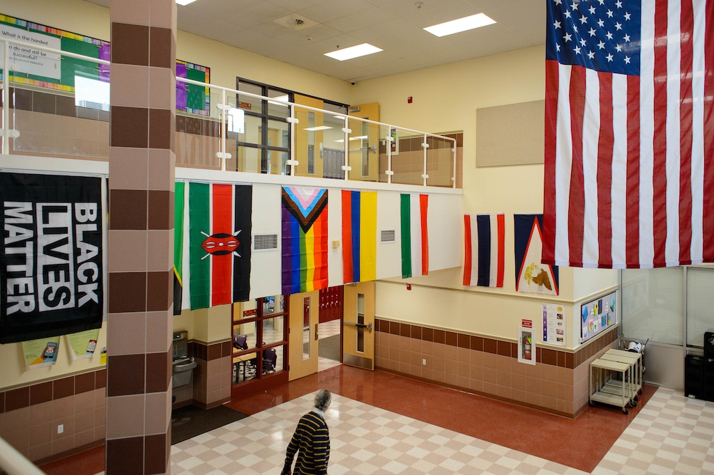(Trent Nelson | The Salt Lake Tribune) The atrium of Rose Park Elementary in Salt Lake City, where on Thursday, Dec. 10, 2020, an LGBTQ pride flag and a Black Lives Matter flag hang along with flags of the United States, other countries, and local tribes. Utah’s new pride flag ban in government buildings takes effect May 7.