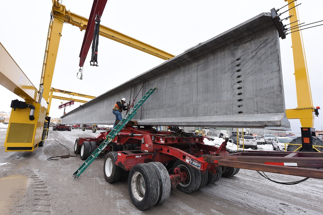 (Francisco Kjolseth  |  The Salt Lake Tribune)  UDOT gets ready to place some of the world's largest-ever bridge beams, and the largest in Utah state history with a span of 203 ft long and just over 8 ft tall, as crews load one on a truck following manufacturing at Forterra Structural Precast in Kearns on Tuesday, Dec. 11, 2018. A total of six beams will be installed in the technology corridor in Lehi later this week.