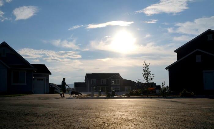 ADVANCE FOR WEEKEND EDITIONS - In this Aug. 16, 2017, photo, Gage Bowls walks his dog Bentley in the Bowls' neighborhood in Spanish Fork, Utah. At birth, Bowls suffered four hours of oxygen depravation which left him with mental and physical deficiencies, including cerebral palsy. (Isaac Hale/The Daily Herald via AP)