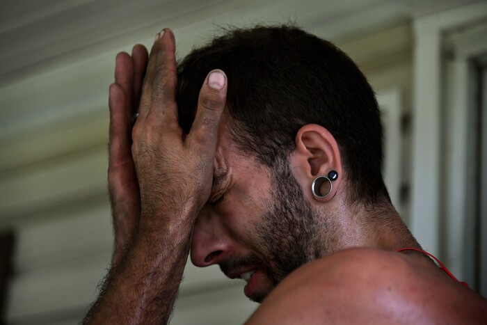 (Washington Post photo by Michael S. Williamson) Phil Manning wipes sweat from his face after spending the afternoon doing yard work on a hot and humid day.