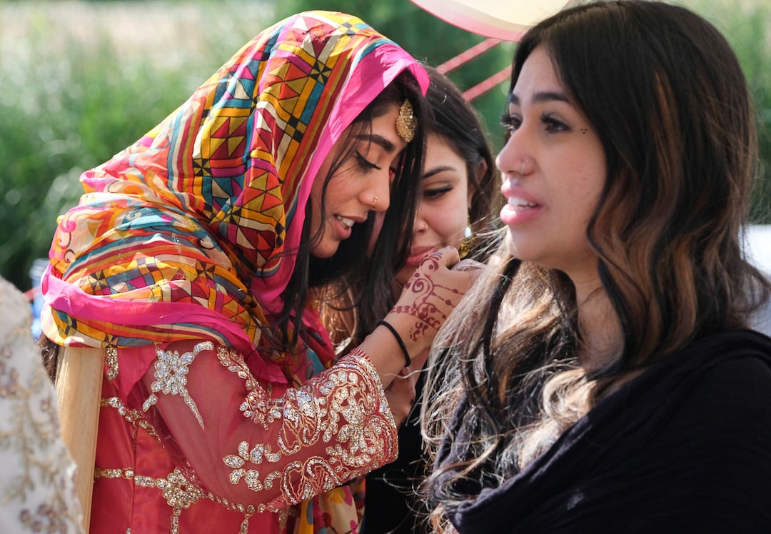 (Francisco Kjolseth  |  The Salt Lake Tribune)  Warda Hashmi, left, looks through photographs with Khadija Nawaz as they are joined by Naomi Jaan, at right, following prayer services at the Khadeeja Islamic Center in West Valley City, mark the end of Ramadan, a 30 day period of fasting and spiritual growth on Wed. June 5, 2019.