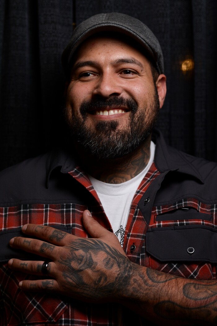 (Leah Hogsten | The Salt Lake Tribune) Vince Vargas shows off his most meaningful tattoo of Jesus Christ on his hand while admiring tattoo artist's work and their designs at the Salt Lake City International Tattoo Convention Saturday, March 17, 2018.