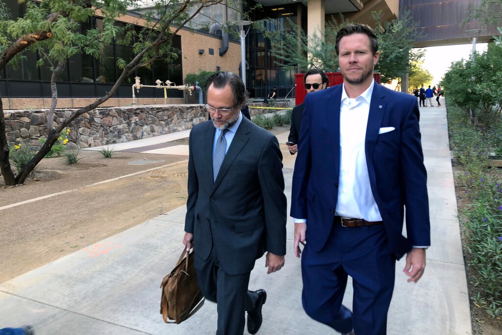 (Jacques Billeaud | AP) In this Nov. 5, 2019, file photo, is former Maricopa County Assessor Paul Petersen, right, with his attorney, Kurt Altman, after a court hearing in Phoenix. Prosecutors in Arkansas are seeking a 10-year prison sentence for Petersen for his conspiracy conviction in running an illegal adoption scheme involving women from the Marshall Islands. He also faces sentencings in Arizona and Utah during January for convictions related to the adoption scheme.